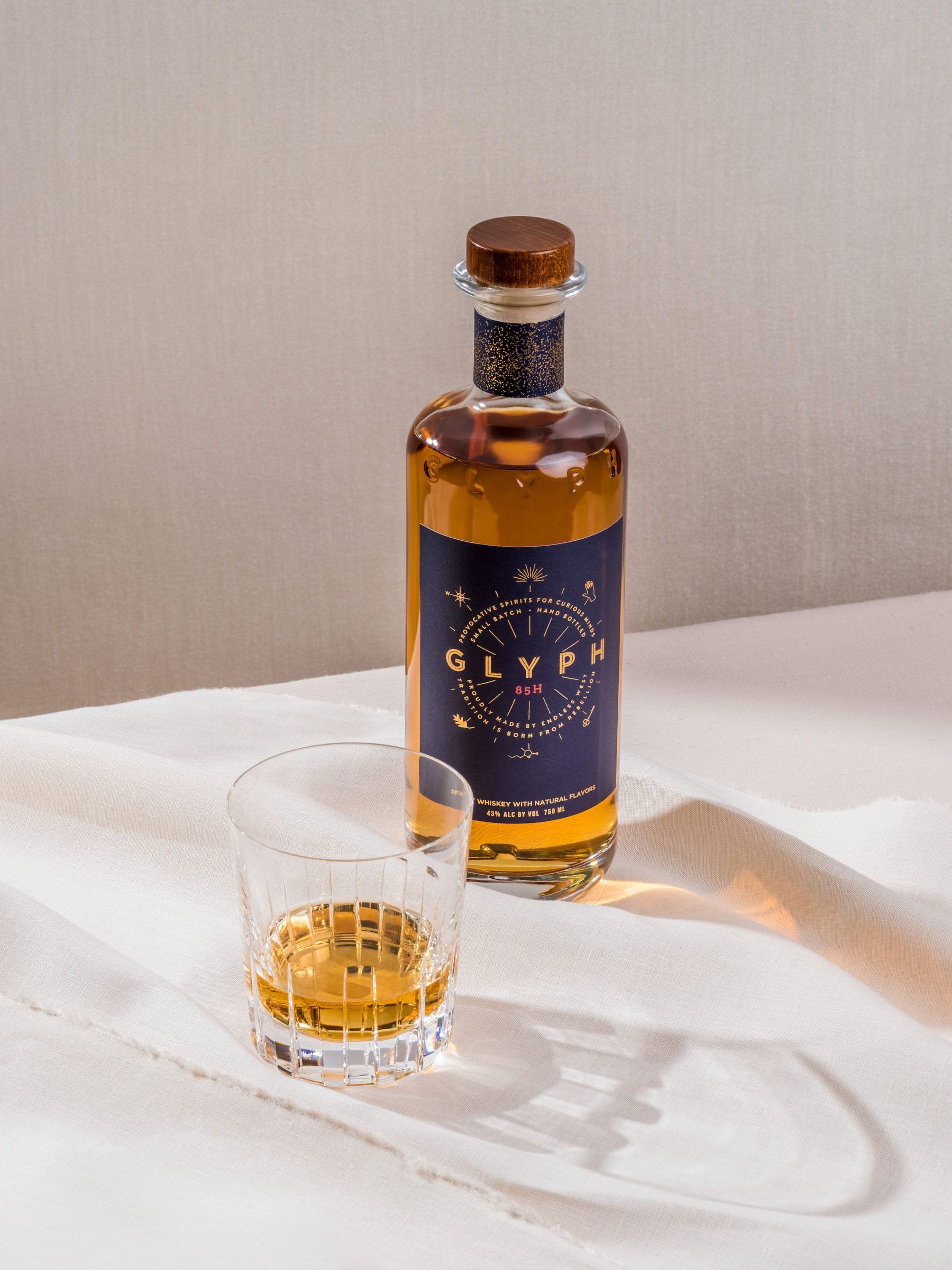 Cover for Endless West showing a bottle of Glyph and a tumbler with whisky