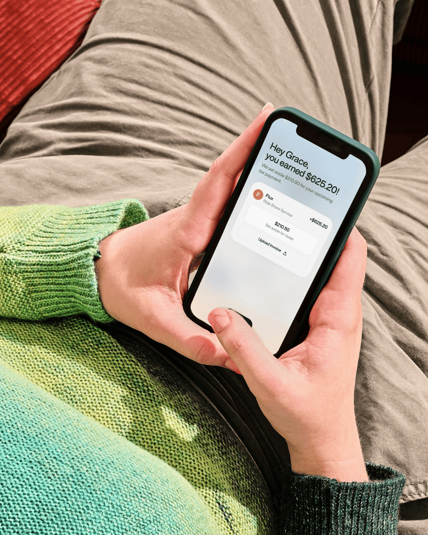 Person holding phone with an income notification from the WorkMade app