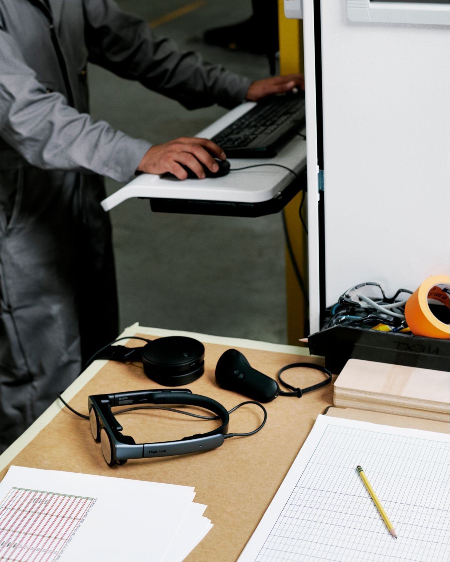 The Magic Leap headset sitting on a desk surrounded by gridded paper.