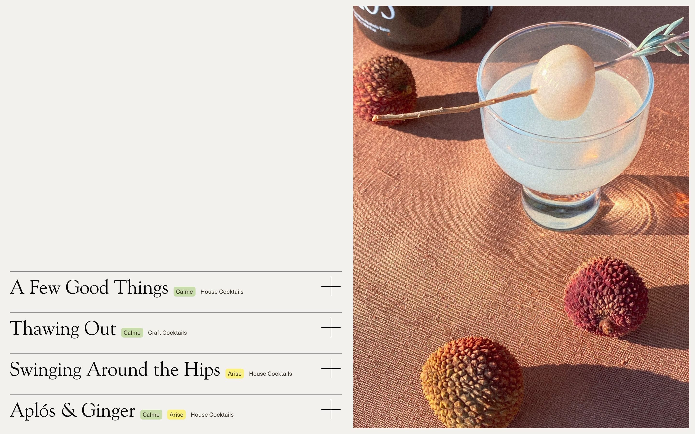 A layout showing an expanding table of recipes on the left, and a photo of a cocktail surrounded by lychees on the right.