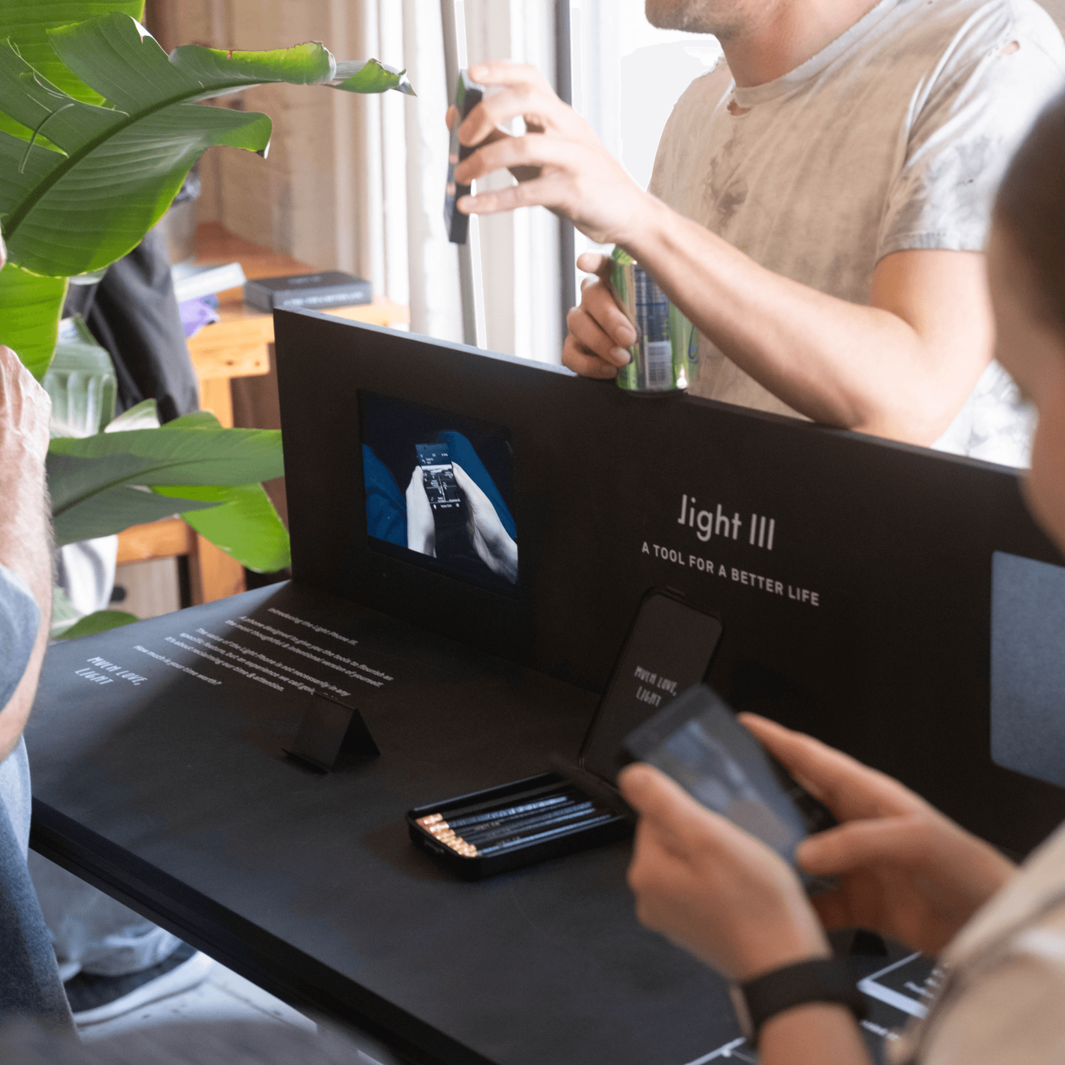Two people inspecting a Light III demo display at the Light Index event in the Index studio.