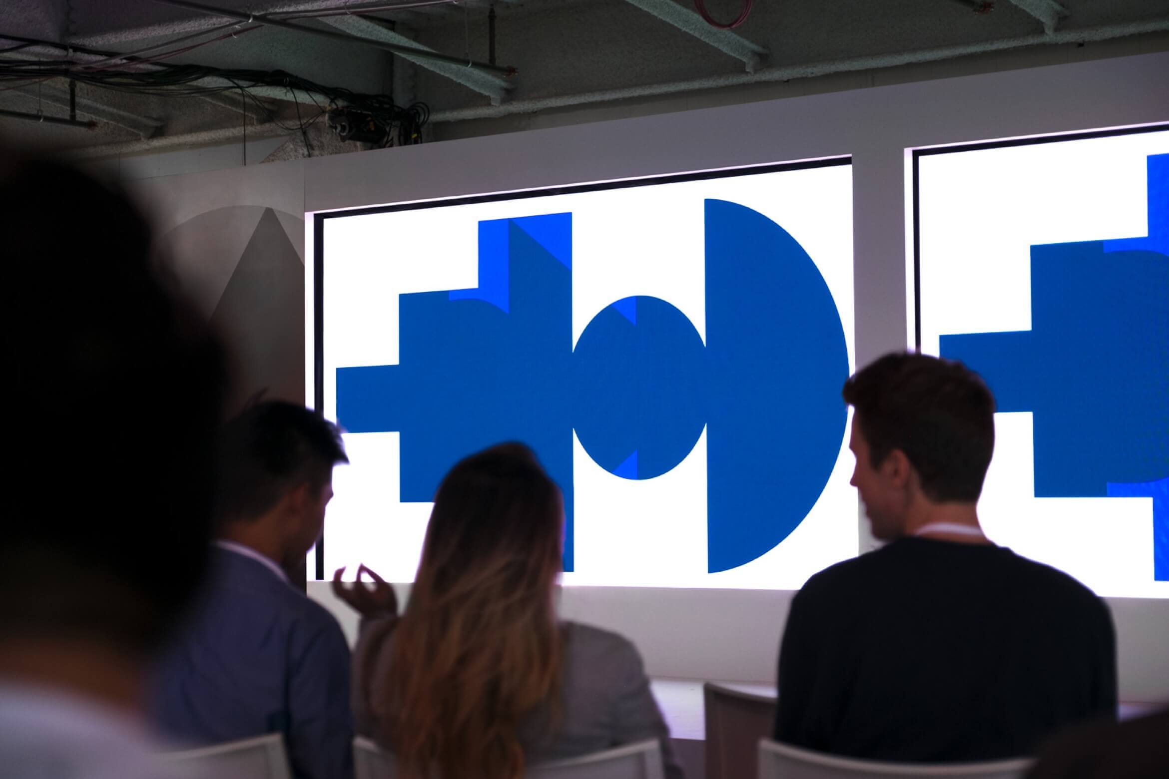 Photo of stage with Google SPAN shapes on displays.