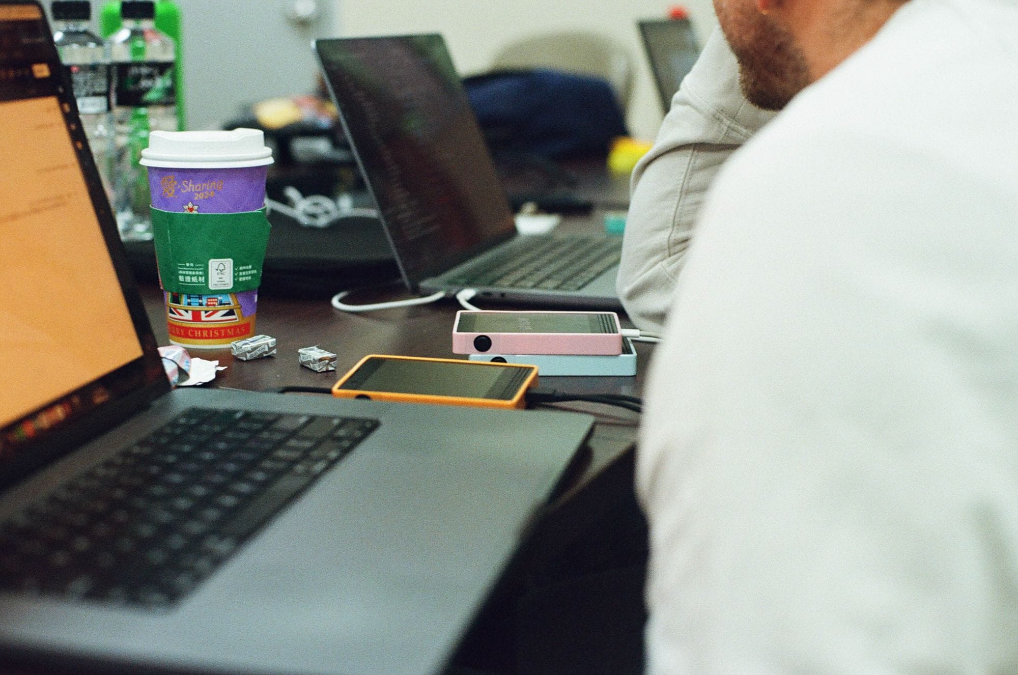 Early Light Phone III DVT-10 prototype sitting on a developer’s desk beside a laptop and coffee cup.