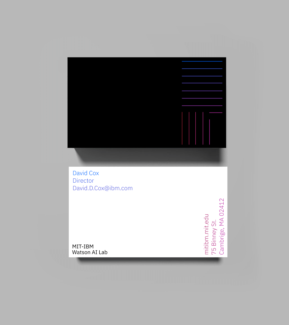 MIT-IBM business cards: a black card with the brand bars and a white card with David Cox’s contact details in MIT red and IBM blue.