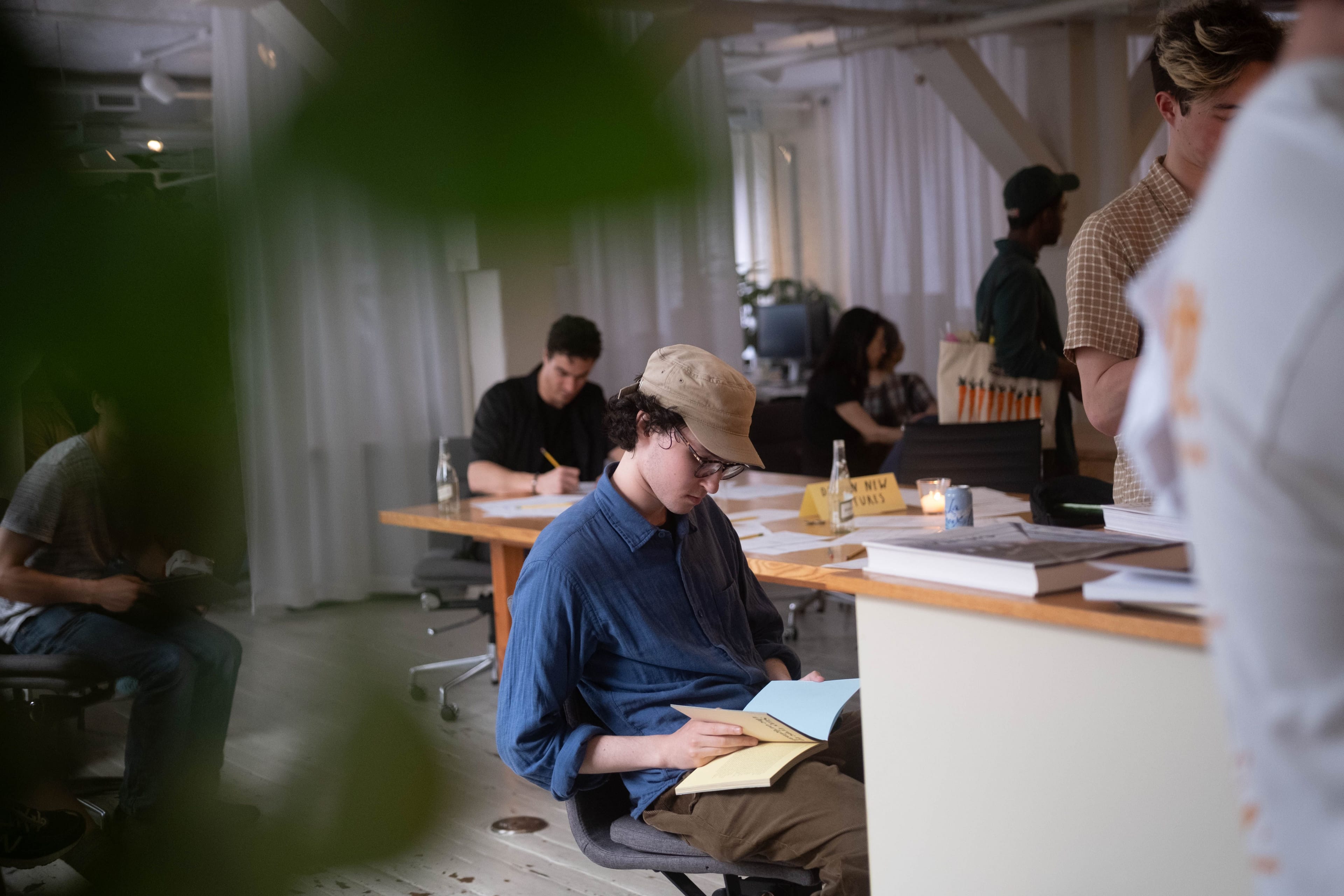 Attendee reading at a table during the Light Index event at Sanctuary Computer’s New York studio.